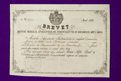 Brevet de decorare nr. 990 a lui Nicolae Stoenescu, medic la Regimentul 14 de Dorobanți Brevetul decorației "Apărătorilor Independenței în Resbelul 1877-1878", clasa a II a, i-a fost acordat în anul 1 — تصویر رکورد یوروپیانا